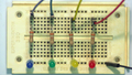 4-bit circuit on breadboard after adding extra wire, resistor, and light to the first column of the breadboard.